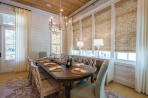 Coastal Dining Room with Roman Shades, White Draperies, and Shiplap