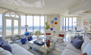 Contemporary living room with waterfront views and bold color. 